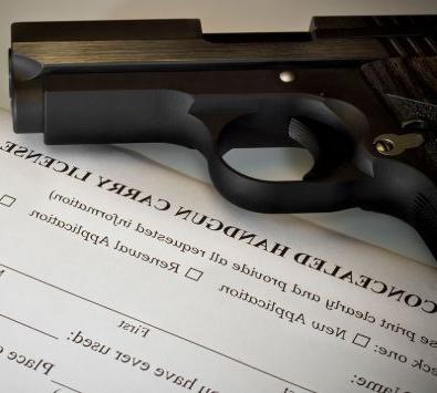 Firearm sitting on top of legal documentation.